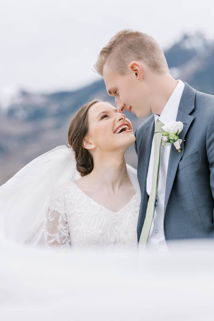 bride and groom wrapped in veil