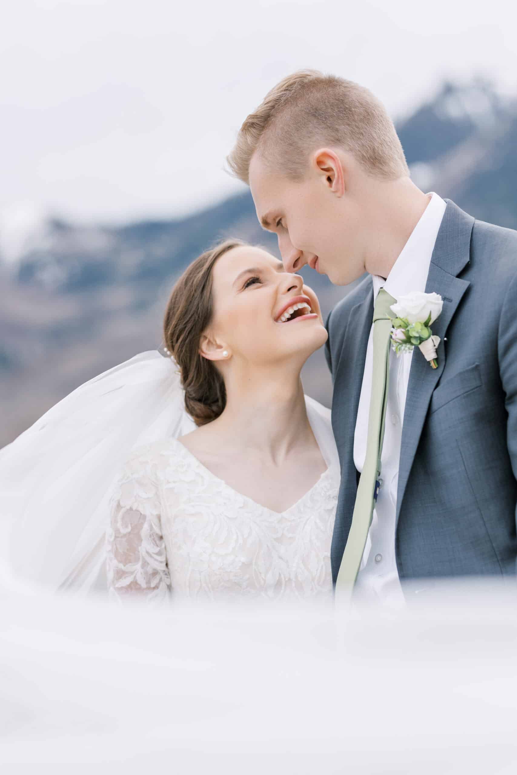 Wedding couple taking bridal photos in mountains